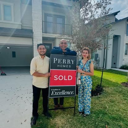 Clients with Perry Homes SOLD sign